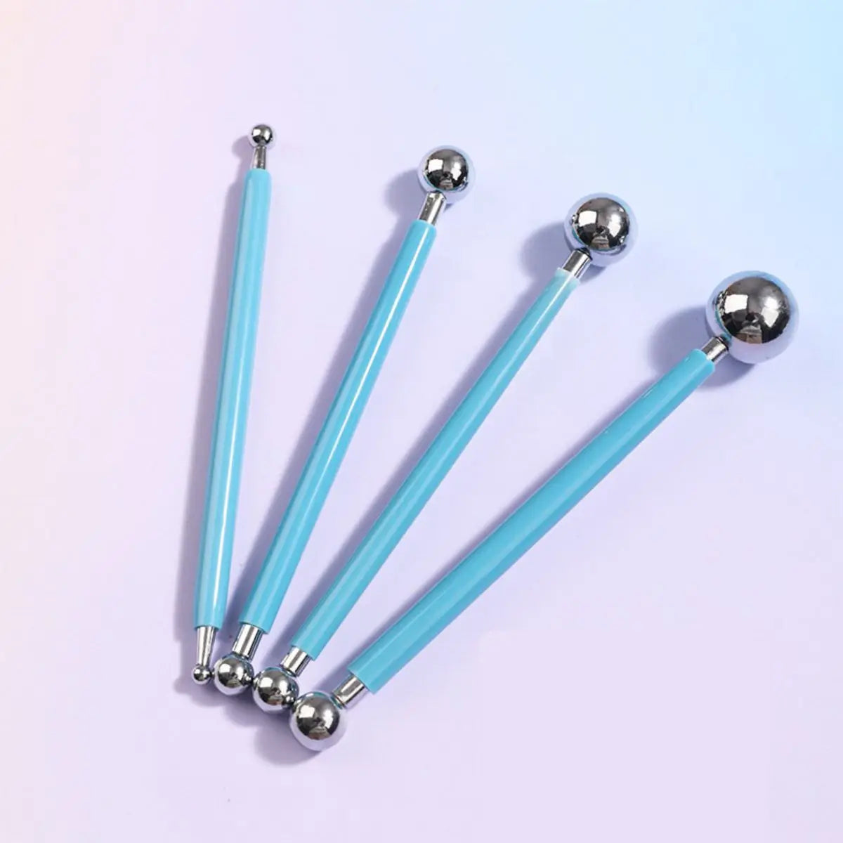 A set of four silver clay sculpting tools with light blue handles for pottery and crafting.