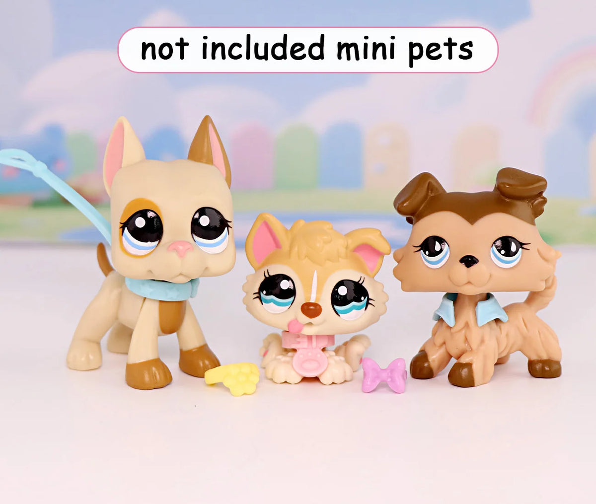 Three small animal figurines with collars and accessories are displayed on a white surface.