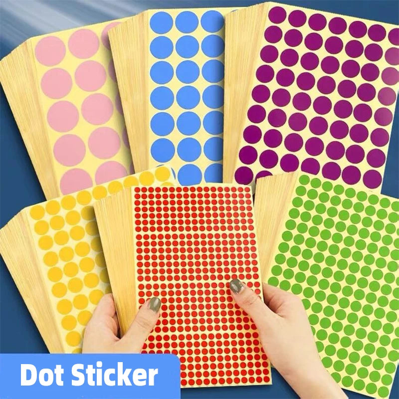 A collection of round self-adhesive dot stickers in various colors like pink, blue, purple, and green are displayed on a dark