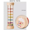 A wooden rain sound shaker toy with colorful beads inside a clear tube for early learning.