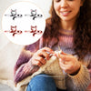 A woman is using an adjustable cat-ear yarn guide ring for knitting or crochet on a piece of yarn.
