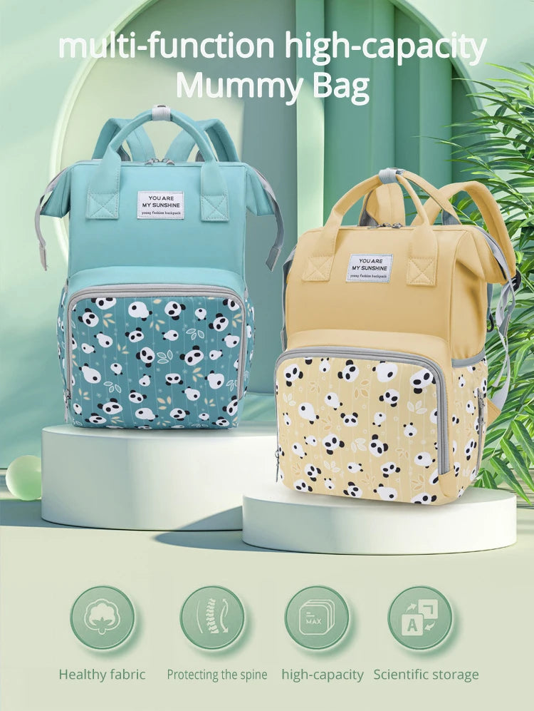 A light blue multi-function high-capacity mummy bag backpack displayed on a white stand with various features listed below.