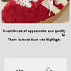 A close-up of a red suede shoe featuring white lace shoelaces and a gold sole.