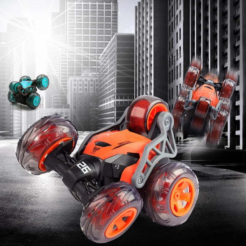 Orange and gray remote control stunt car with large wheels performing a stunt in a city background.