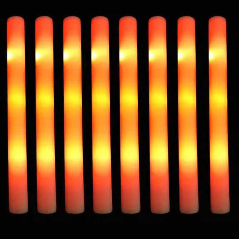 A row of glowing orange LED glow sticks against a black background.