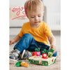 A toddler is playing with a Montessori carrot pull toy, which is soft and washable for sensory learning.