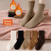 A set of women's fleece-lined slouch socks in various neutral and dark earth tones displayed on a pink fabric.
