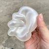 A hand holds a translucent, squishy stress ball shaped like a leaf, used for relaxation.