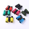 A collection of colorful kids binoculars in various colors including red, black, pink, green, and yellow.