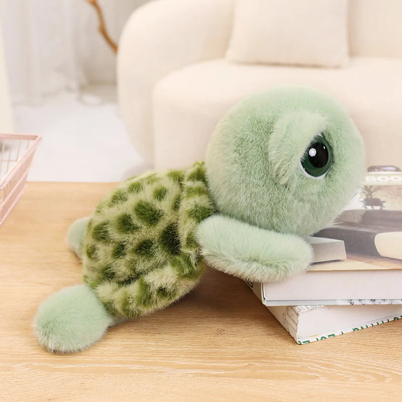 A soft, light green sea turtle plush toy with large eyes resting on a wooden surface.
