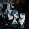 A set of premium glitter resin polyhedral dice including a d10, d8, and d6 resting on a reflective black surface.