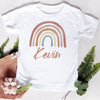 White t-shirt featuring a rainbow arch design and the name Kevin printed in brown ink