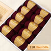 A box of Merino wool yarn in deep burgundy color, packaged with labels indicating 11 skeins totaling 500g.