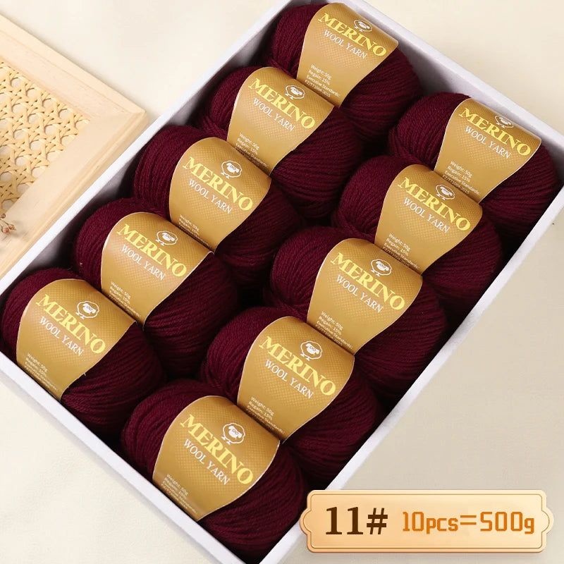 A box of Merino wool yarn in deep burgundy color, packaged with labels indicating 11 skeins totaling 500g.