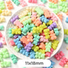 A bowl filled with pastel bear-shaped acrylic craft beads in various colors and sizes.