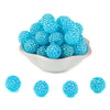 A pile of bright blue rhinestone resin bayberry beads for jewelry making