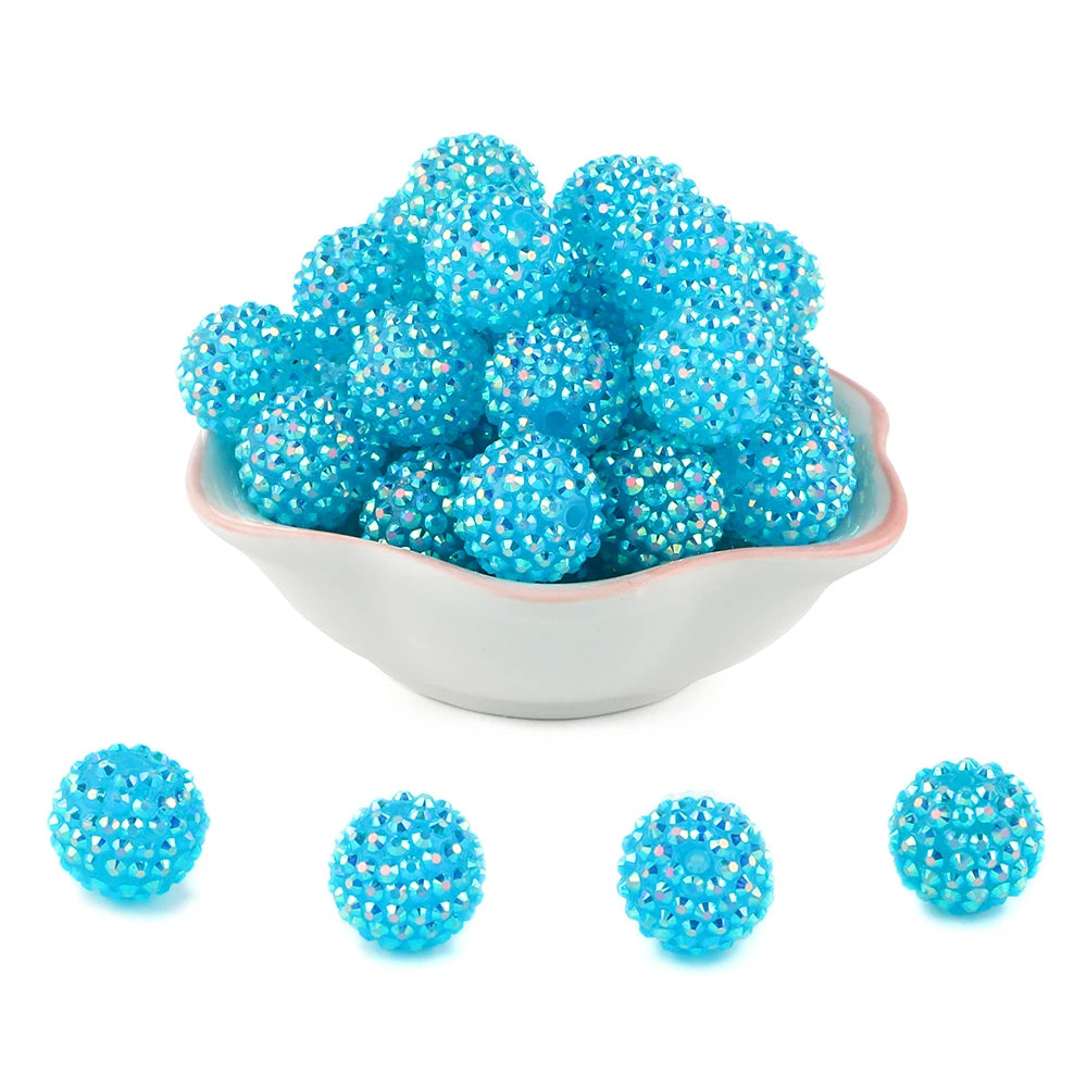 A pile of bright blue rhinestone resin bayberry beads for jewelry making