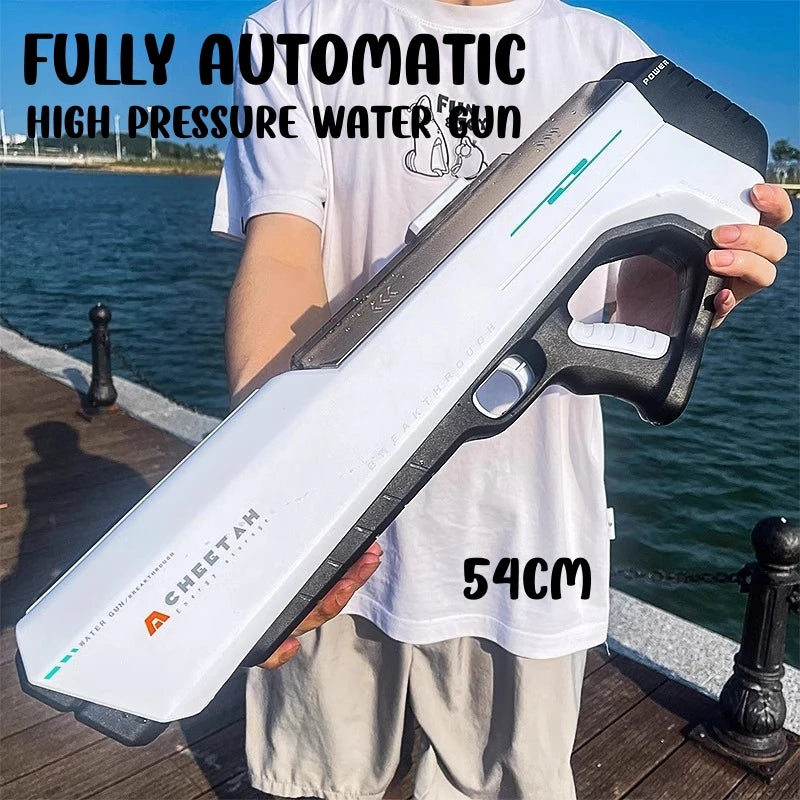 A person holds a white high-pressure water gun with a black grip and green accents outdoors.