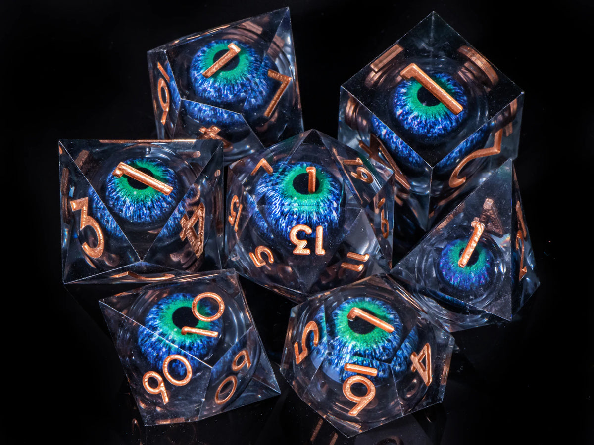 A collection of seven liquid core resin polyhedral dice, including a d10 and d12, displayed against a dark background.