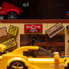 A close-up of a LEGO building set depicting a classic garage with tools and a yellow car model.