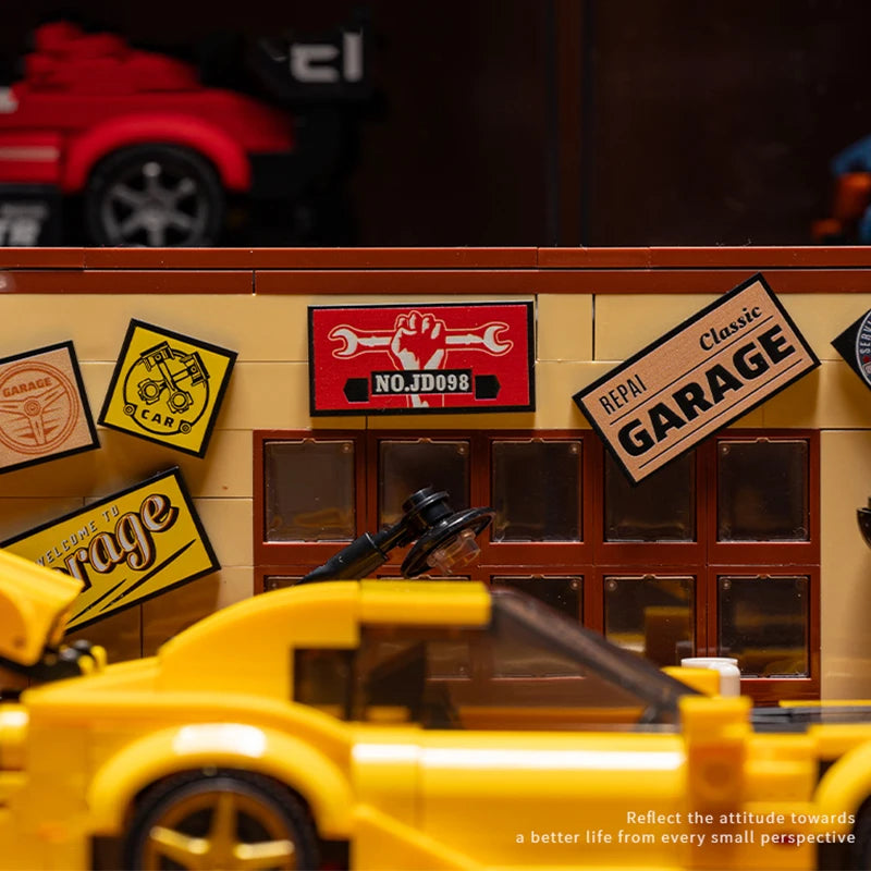 A close-up of a LEGO building set depicting a classic garage with tools and a yellow car model.