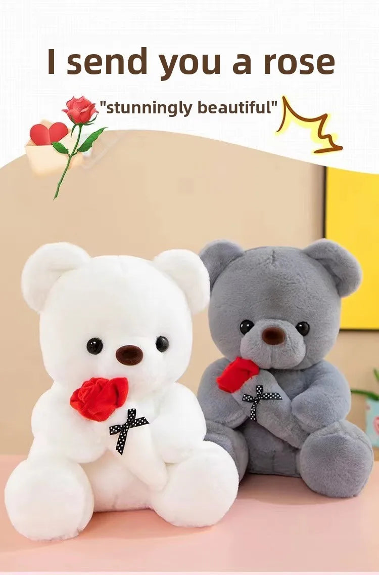 A white plush bear holding a red rose and a gray plush bear sitting next to it.