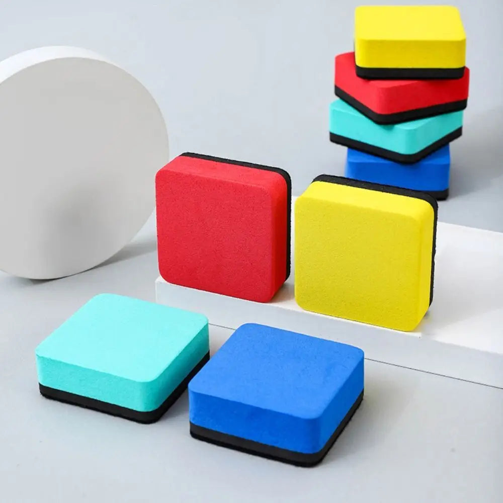 A set of five colorful magnetic whiteboard erasers made of EVA felt pads stacked on a white surface.