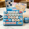 A blue keyboard keycap clicker set with various animal and food themed keycaps and a guide card is displayed next to an iced 