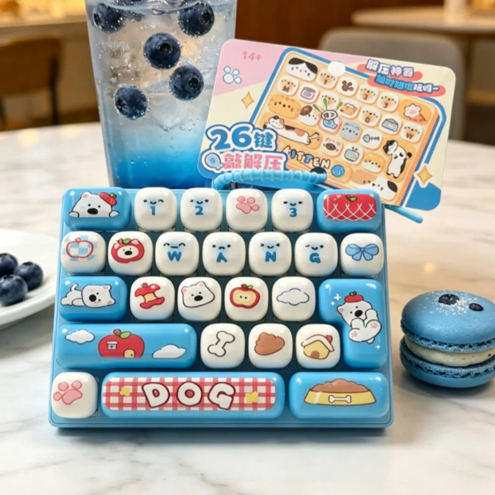 A blue keyboard keycap clicker set with various animal and food themed keycaps and a guide card, next to an iced drink.