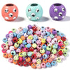 A collection of colorful, iridescent rhinestone acrylic spacer beads in various shades of pink, purple, and green.