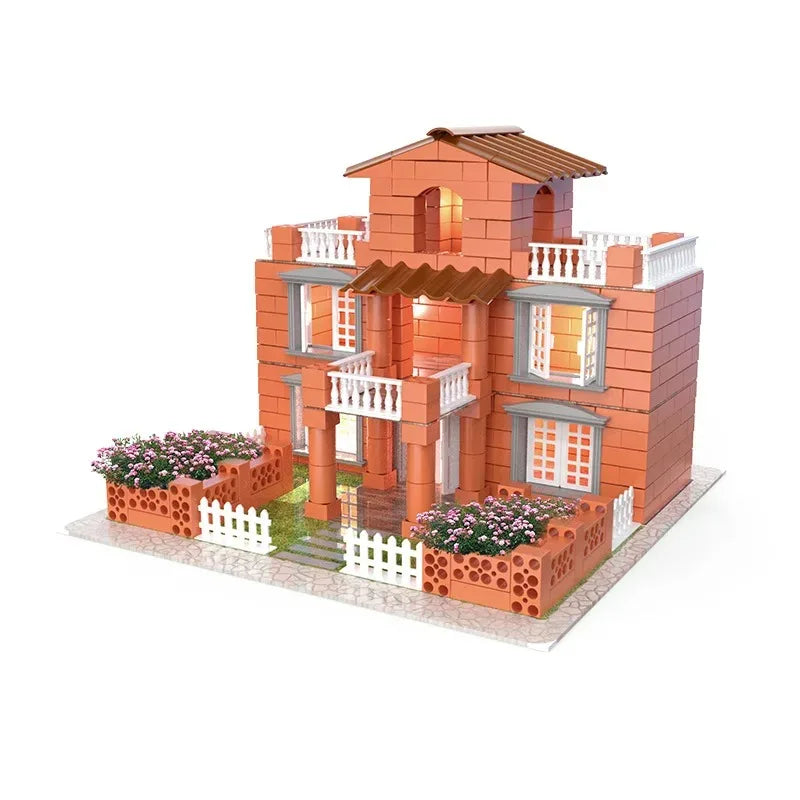 A miniature brick building set featuring a two-story house with orange bricks, white trim, and flower beds.