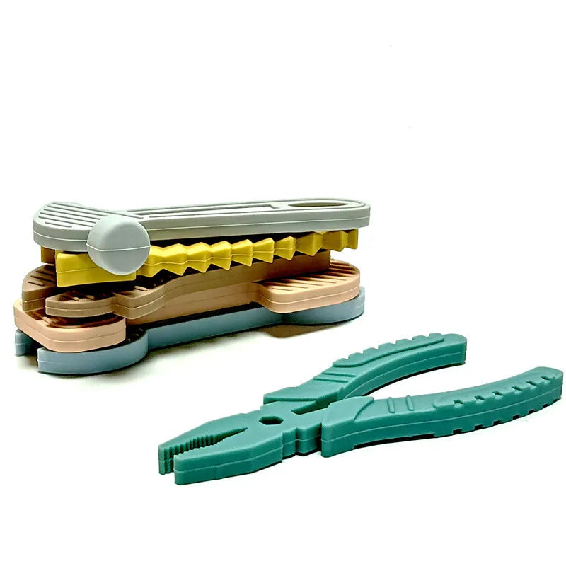 A set of silicone baby teether toys in various colors and tool shapes for chewing and teething.