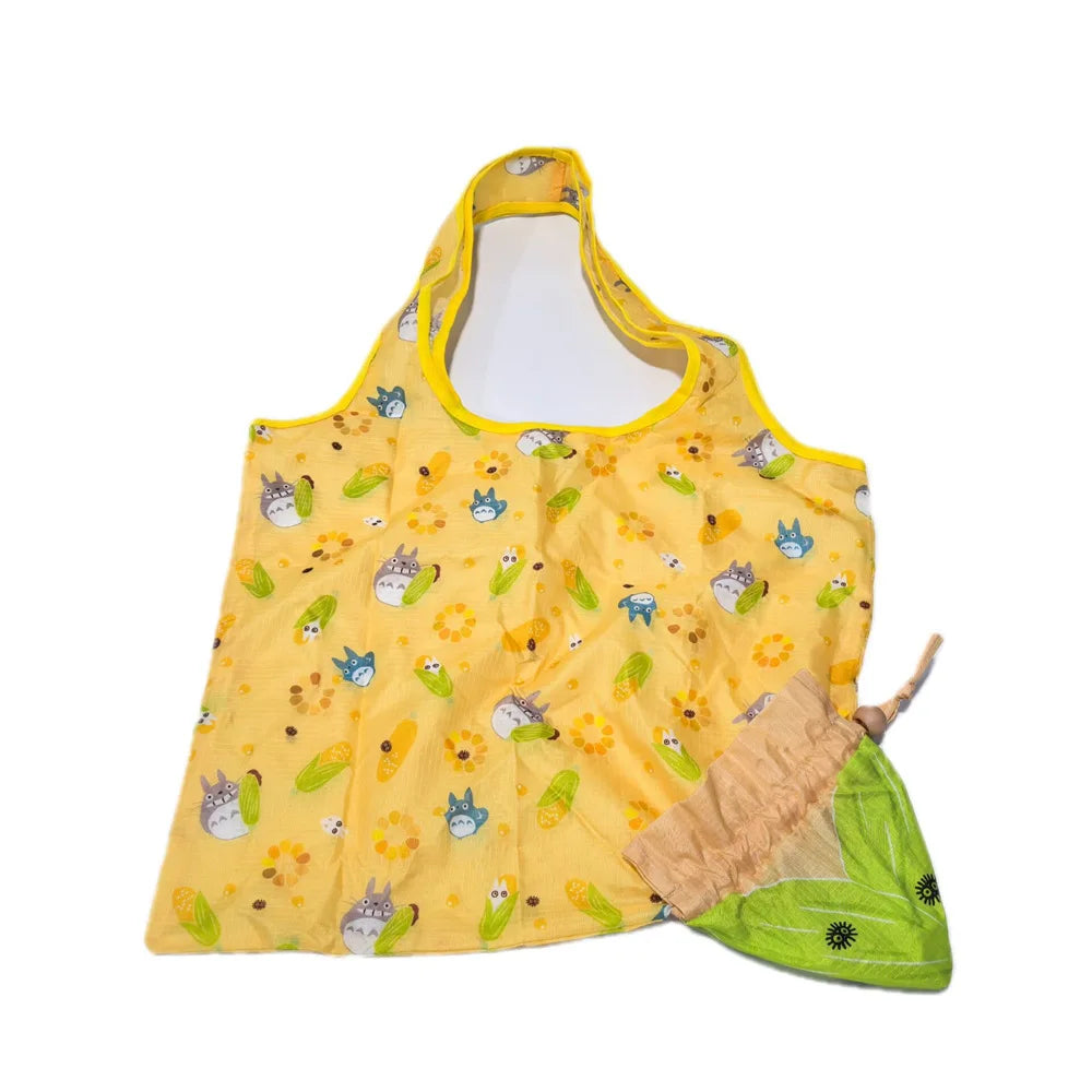 Yellow sleeveless shirt with a pattern of small animal faces and green leaves