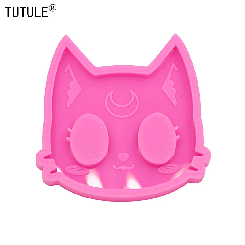 A pink silicone mold shaped like a cat's head for DIY keychains and craft projects.