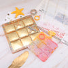 A silicone mold for creating customizable tic-tac-toe game pieces, featuring a square tray and a pink molded piece.