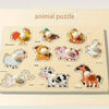 A wooden animal puzzle board featuring various animals like a rooster, duck, pig, cow, and horse for early learning.