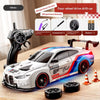 A white four-wheel drive drift car model is shown with various tools and accessories on a wooden surface.