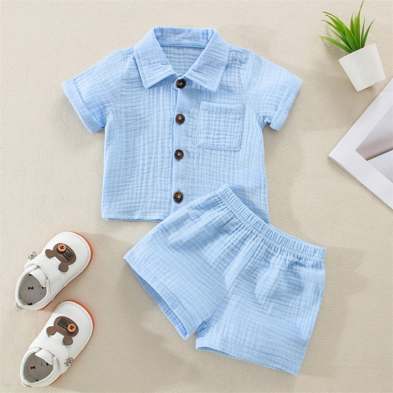 A light blue baby boy cotton linen outfit set consisting of a short-sleeved shirt and matching shorts.