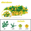 A set of green and yellow building blocks shaped like cherry blossom trees, including various pieces.