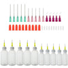 A collection of precision dispensing kit components including blunt needle tips and various colored squeeze bottles.
