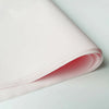 A roll of translucent pink tissue paper sheets for gift wrapping or flower bouquets.