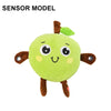 Un jouet en peluche vert doux, en forme de fruit avec de petits yeux et des membres bruns.
