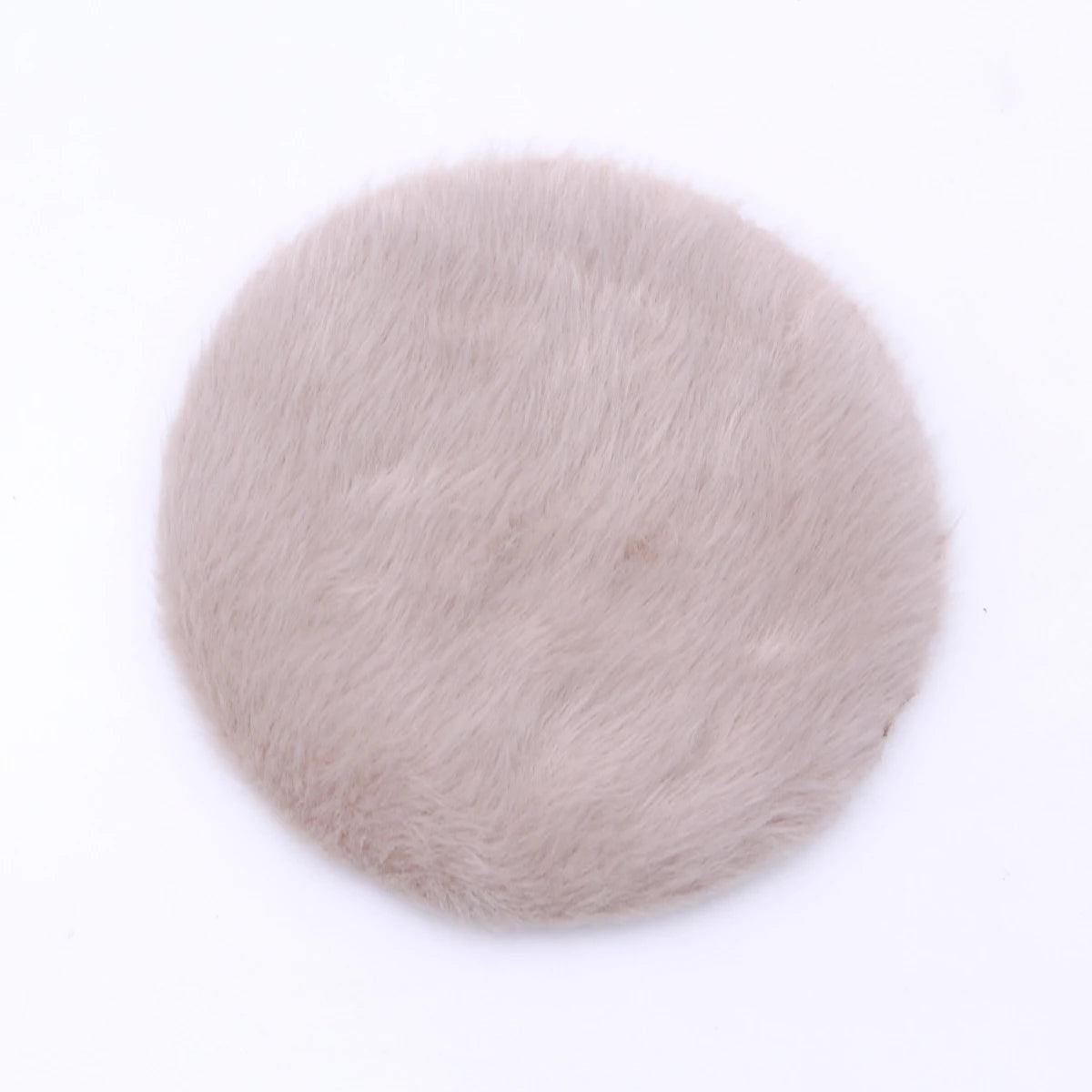 A round, light beige handwoven Turkish style miniature carpet mat for dollhouse decor.