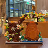 A detailed building block pen holder and desk organizer shaped like a tree with flowers and a capybara face.