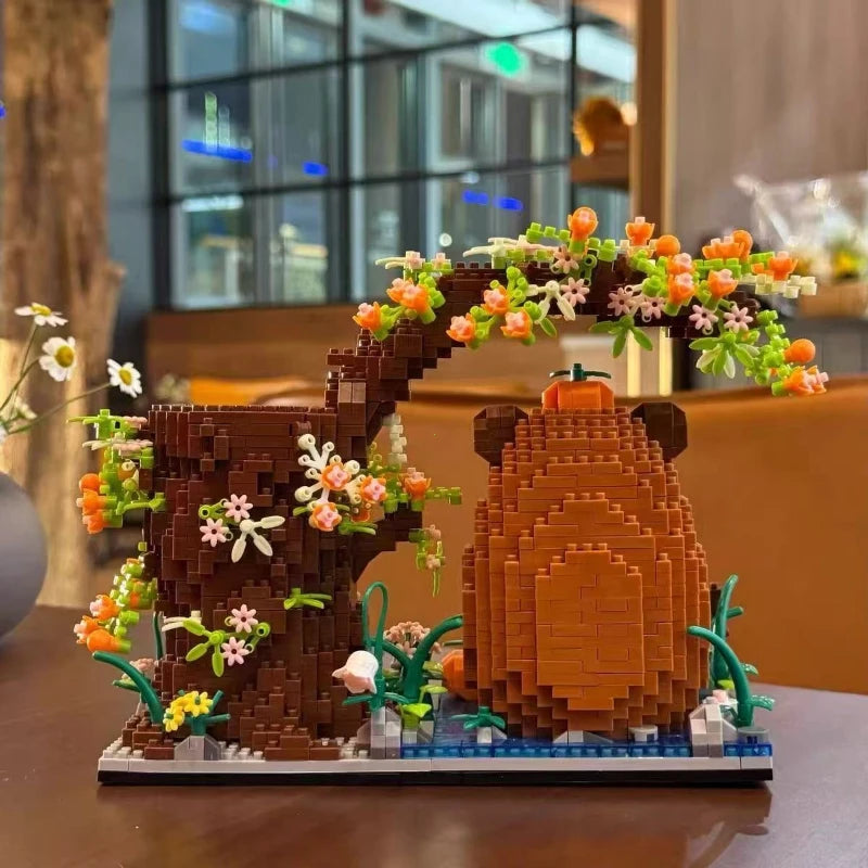 A detailed building block pen holder and desk organizer shaped like a tree with flowers and a capybara face.