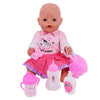 A pink baby doll with a bald head is shown with feeding and care accessories including a pink bottle and a pink brush.