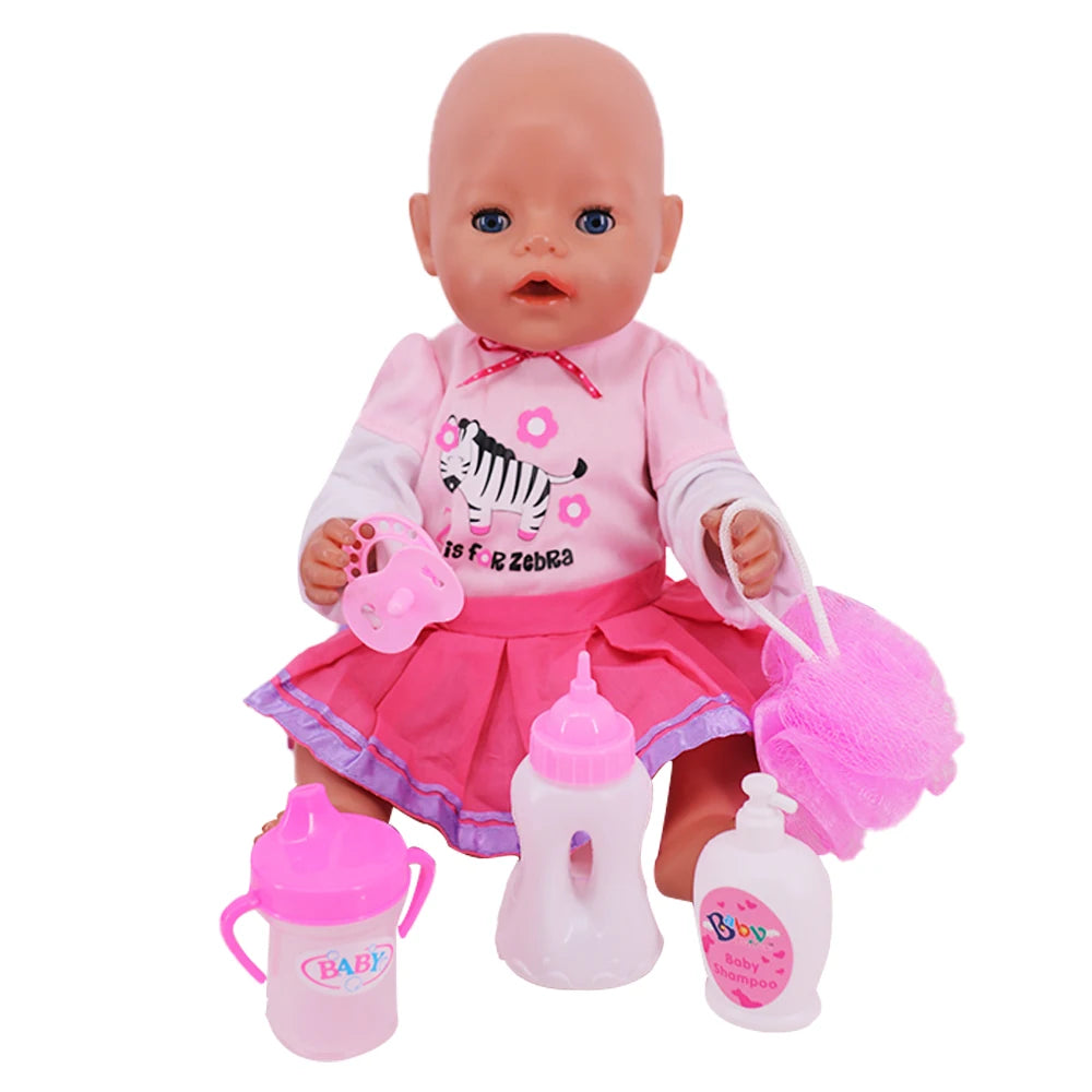 A pink baby doll with a bald head is shown with feeding and care accessories including a pink bottle and a pink brush.