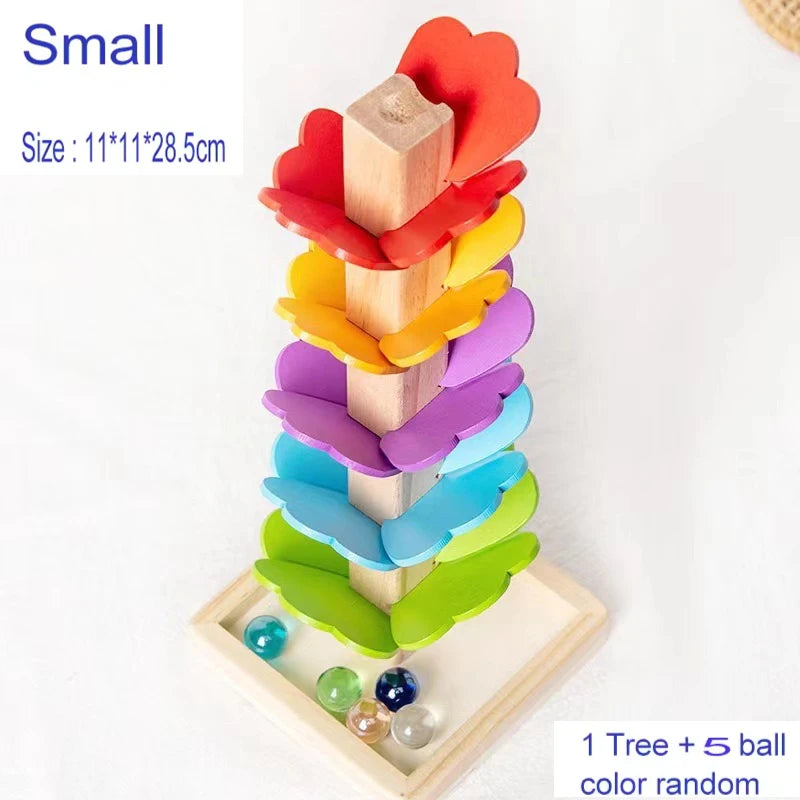 A wooden rainbow ball track toy featuring five colored blocks stacked vertically.