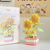 A miniature flower bouquet building block set featuring yellow and pink flowers in a wooden planter.
