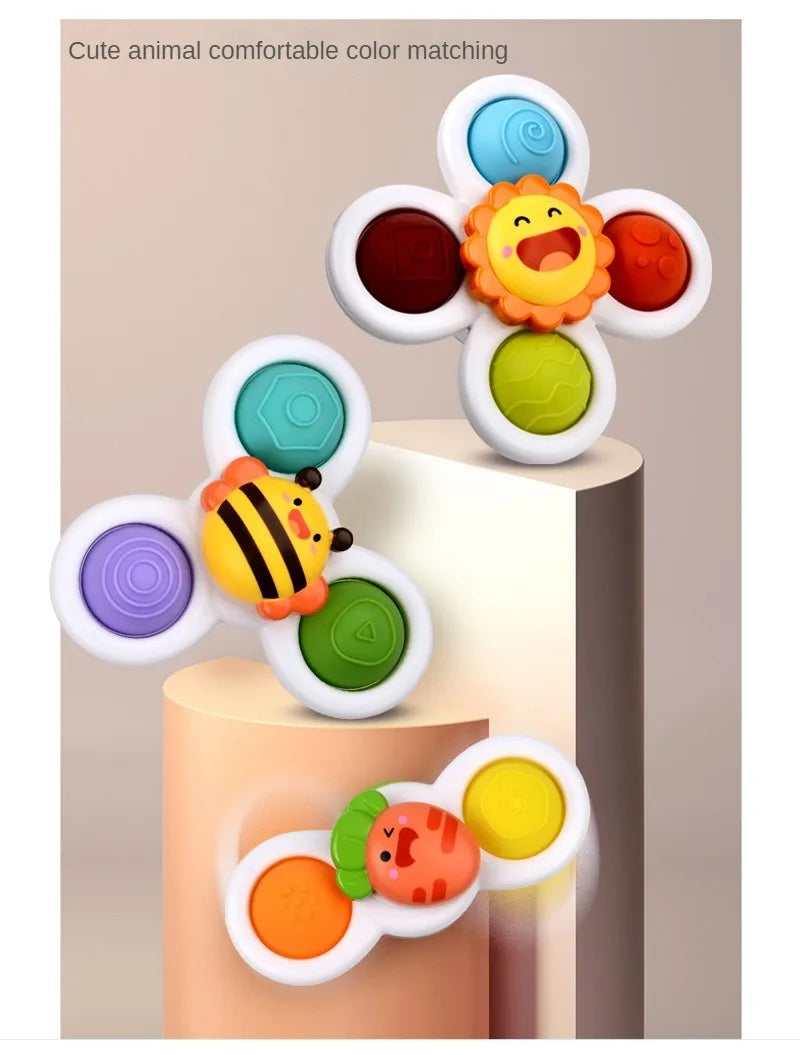 A set of three colorful suction cup spinner bath toys featuring animals like a bee, a smiling face, and a striped fish.